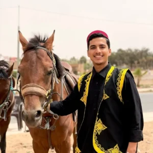 Local Moroccan guide standing with his horse in Agadir