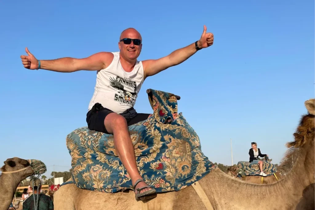 Man celebrating during an agadir camel ride excursion in Agadir.
