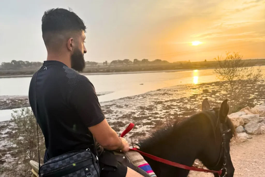 Tourist enjoying a scenic sunset horseback ride – Horse Riding Agadir