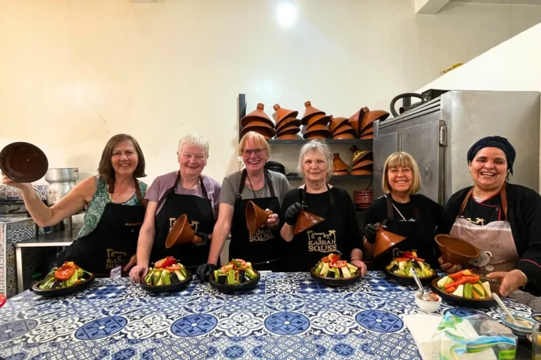 Tourists smiling after preparing traditional tagine during Agadir Cooking Class