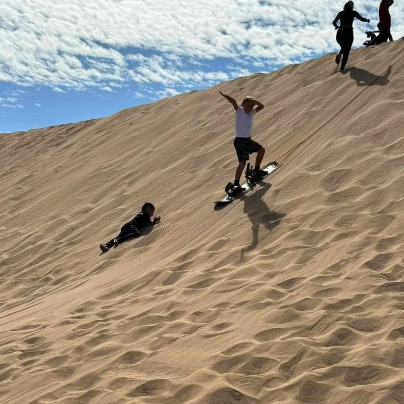 Children and adults sandboarding in Agadir – family-friendly sandboarding Agadir experience