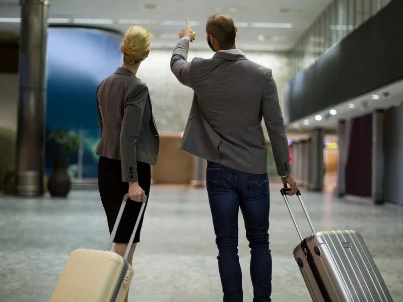 Agadir Airport Transfer – business travelers walking inside Al Massira Airport terminal