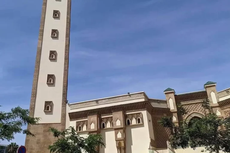Street view of a mosque with a tall minaret in Agadir