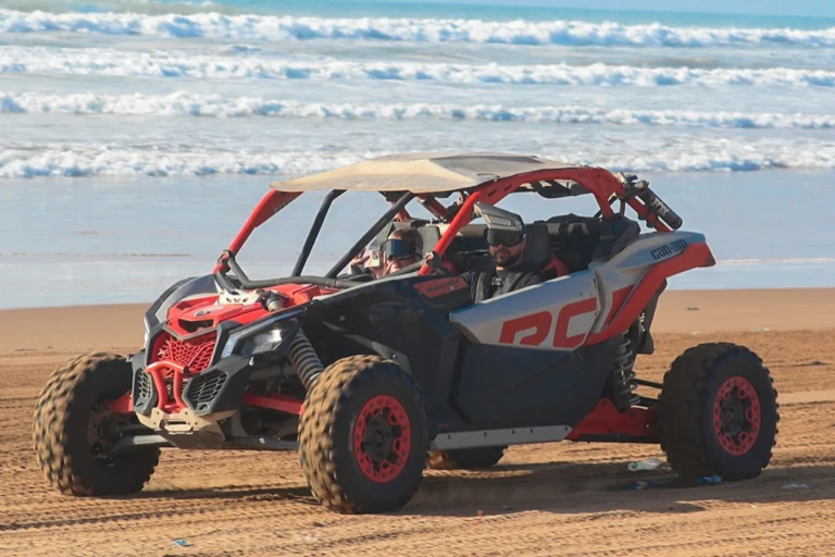 Dune buggy driving along the beach near Agadir with the ocean behind