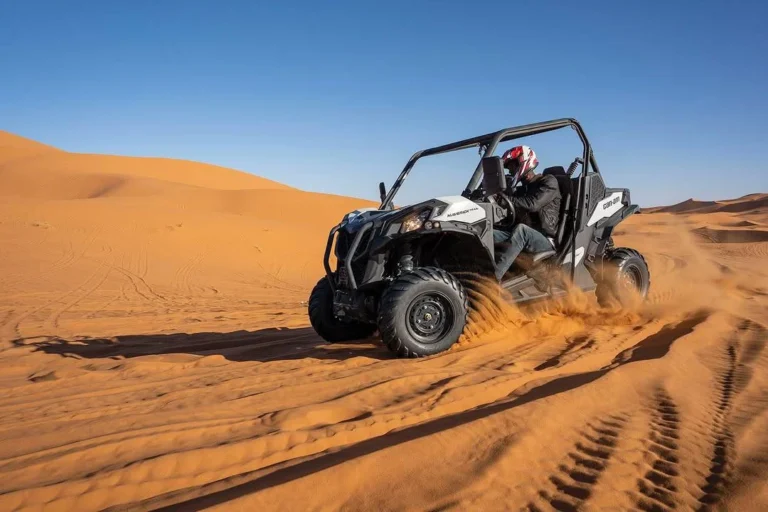 Dune buggy kicking up sand while driving through the dunes near Agadir