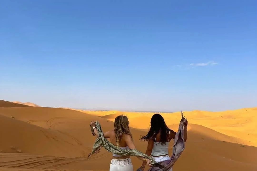 Travelers on a Sahara dune walk during an Agadir tours desert excursion