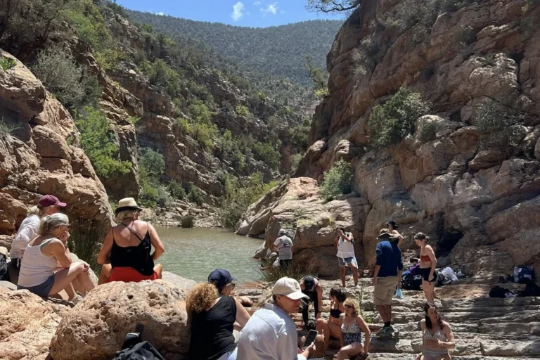 Travelers swimming and relaxing in the natural pools of Paradise Valley