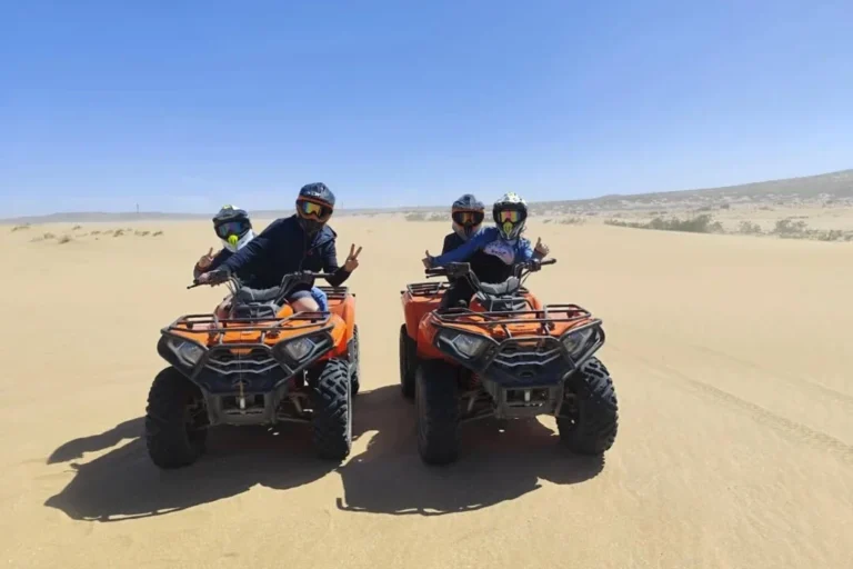 Riders on quad bikes pausing on the sand dunes near Agadir