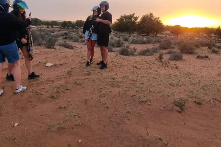 Travelers taking a break in the desert during a quad biking sunset tour near Agadir