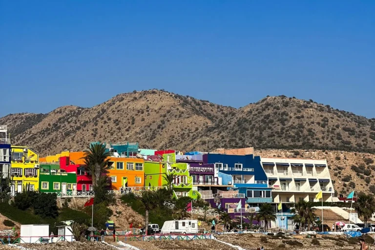 Colorful houses of Taghazout village on the hillside above the beach