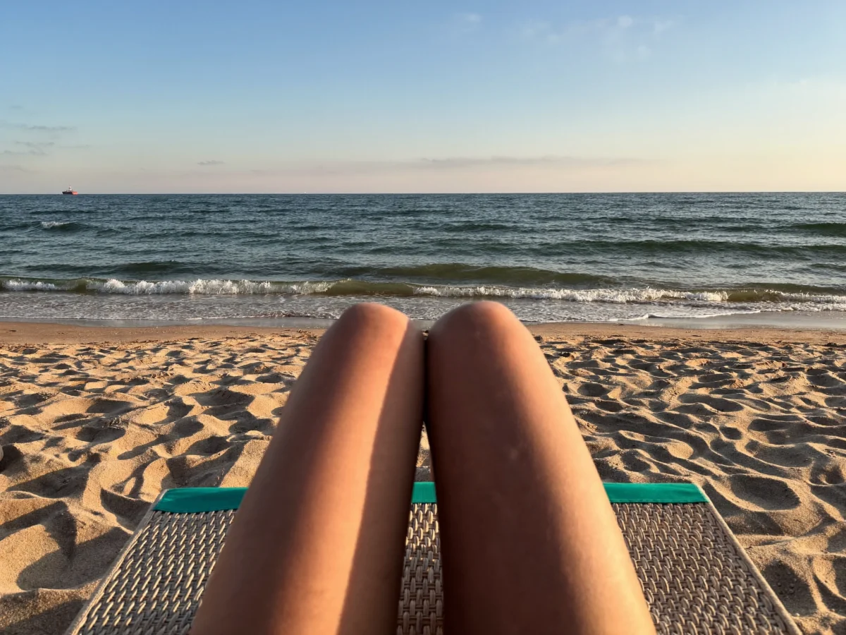 Person relaxing on a quiet Atlantic beach in southern Morocco in late afternoon light